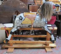 A small Victorian style dapple grey rocking horse, with real horse hair mane and tail.