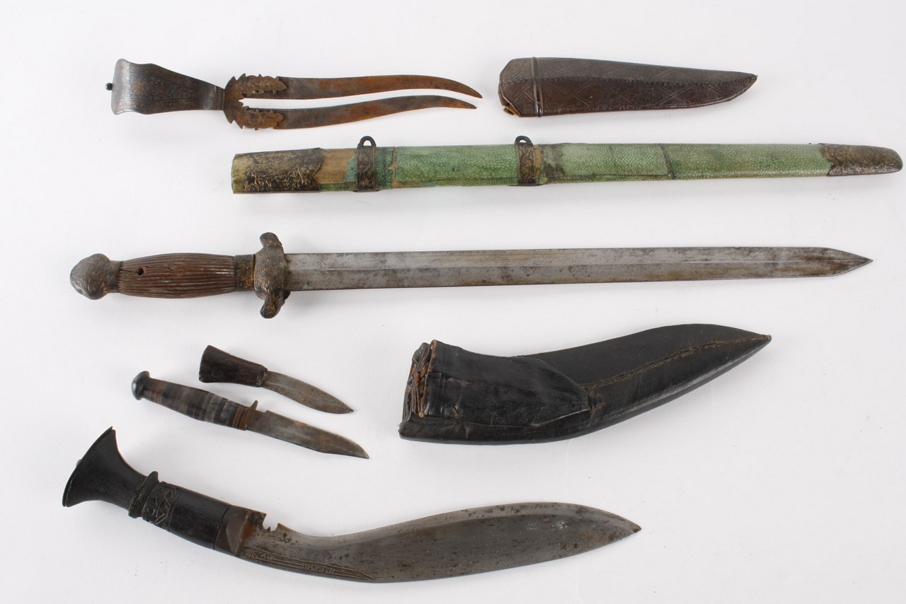 A Chinese short sword in a wood and green shagreen scabbard; a kukri; and a Near Eastern knife