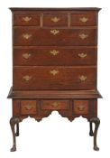 A George II oak chest on stand circa 1750, moulded cornice above three short and three long drawers,