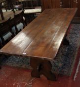 A stained oak trestle table 181cm length