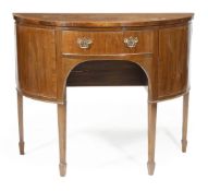 A George III style mahogany bow front sideboard, frieze drawer, cupboard door on either side, square