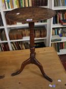 An early 19th Century provincial oak tripod table and another similar