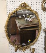 A Victorian oval two branch wall mirror 74cm high, 57cm wide