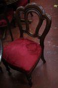 A set of six Victorian mahogany balloon back dining chairs each with shaped back and red damask