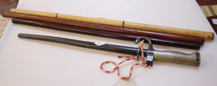 A German bayonet and three swagger sticks, to include one with inscription `Capt. Dumas 1943 (26