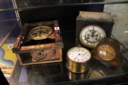 Four mantel clocks in varying states of disrepair, including a French eight-day example with visible