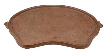 Robert Mouseman Thompson, an oak kidney shaped tray, with an adzed surface and carved with two
