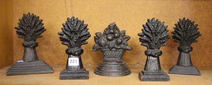 Five various 19th century cast iron door stops (cast sheaves of wheat)