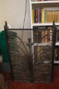 A three section wirework fireguard with scrolling and floral detail 94cm high