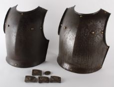 Two iron breast-plates; together with assorted German Second World War belt buckles and badge.