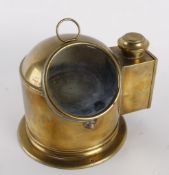 A brass ship`s compass with oil lamp attachment