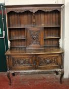 A late Victorian carved and stained oak dresser, circa 1880