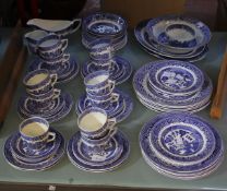An Old Willow pattern part dinner and tea service, comprising: teacups, saucers, bowls and plates.