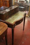 A reproduction serpentine fronted side table and a reproduction writing table in Regency style