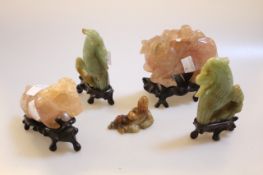 Chinese rose quartz ox and goat on wooden stands, a pair jadeite bird models on wooden stands and