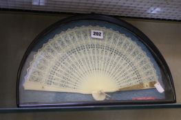 A Chinese Canton style plastic `brise` fan, decorated with openwork floral and geometric designs,