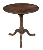 A George III mahogany tilt top tripod table circa 1780 with a circular top on birdcage on a ring