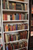 Eight shelves of books, mostly novels and a few reference books and some Ordnance Survey Maps.