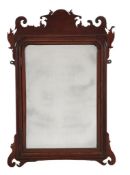 A medal cabinet in the form of a George II style wall mirror, early 20th century, the shaped