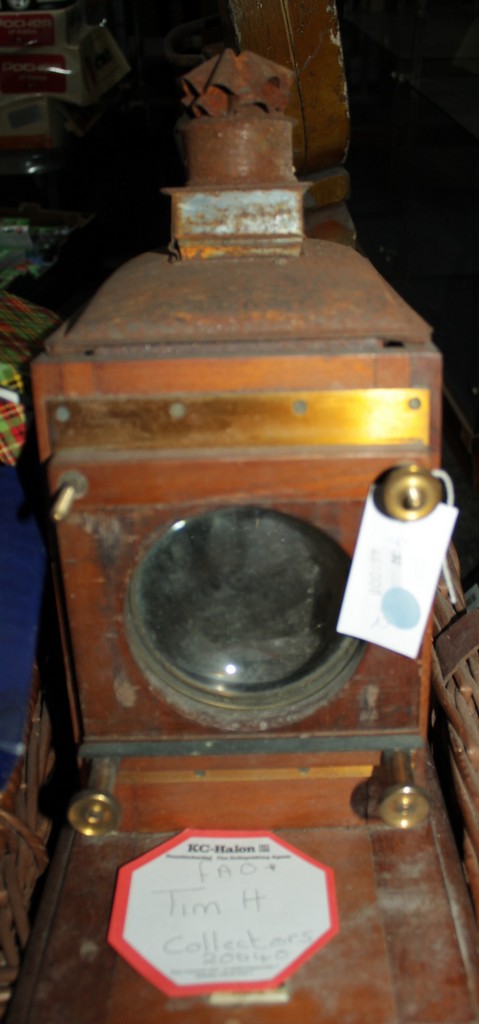 A tinplate and brass Magic Lantern, with a wooden case and cane carrying case.