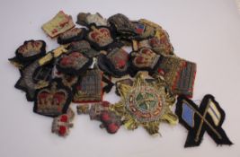 A quantity of enamel and some silver badges, medals, army buttons, etc.