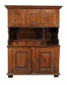 A Continental walnut cupboard, second half 18th Century, the moulded cornice above three panelled