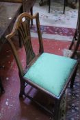 A set of five 19th Century oak dining chairs each with arched pierced splat and drop in seat