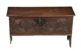 A Charles II oak coffer, circa 1660 and later, with hinged lid opening to storage compartment,