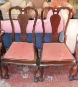A set of six George II style mahogany dining chairs each with vase splat on claw and ball feet.
