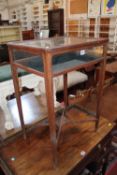 An Edwardian mahogany display table with an X-framed stretcher 75cm high, 50cm wide