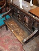 A Victorian oak bench with carved back and frieze on turned front legs 107cm wide