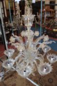 A Venetian style glass eight branch electrolier with additional decorative fronds and flowers;
