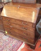 A George III mahogany bureau with a fitted interior and four long drawers, 107cm.