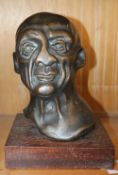 The Pugilist, a bronze bust of a boxer, indistinct signature verso; 23cm high