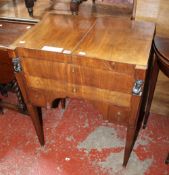 An Empire mahogany night stand with with hinged lid, revealing an adjustable mirror, with three