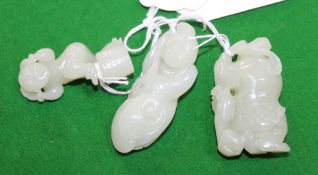 Three Chinese celadon jade carvings in the form for boys holding lingzhi fungi, a chilong beside