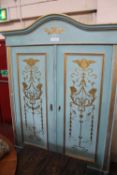 A Louis XV style gilt decorated and painted armoire 214cm high, 155cm wide