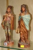 A pair of Austrian terracotta figures; 33cm high and a Japanese porcelain tray; 36cm x 36cm Best