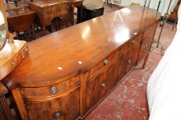 A Rackstraw breakfront yew wood sideboard with five drawers and cupboards below 92cm high, 250cm