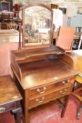 A Georgian style mahogany dressing table with a mirror back, two drawers and shaped undertier 66cm