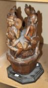 A South East Asian carved wooden figural group on hexagonal base; 48cm high