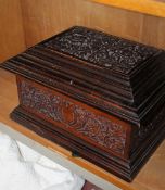 A carved walnut case/mahogany box, late 19th/early 20th century; 22cm high x 38cm wide x 29cm deep
