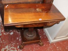 A William IV mahogany card table, with a carved frieze, on reeded outwept column on square platform