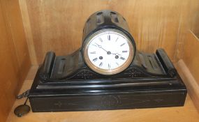 A black marble drum clock with white enamel dial; 40cm wide