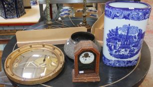 A blue and white ceramic stick stand, a brass bowl, a circular wall mirror etc. Best Bid