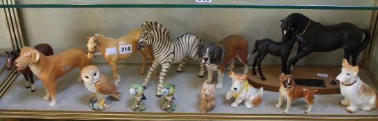 An assortment of Beswick animals to include a Zebra, various dogs, two blue tits, an owl, `Black