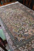 A Kashan style rug, the cream field and pink borders decorated with foliage and boteh throughout,