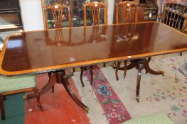 A reproduction mahogany twin pedestal dining table, in Regency style with one additional leaf 228cm