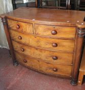 A Victorian mahogany bowfront chest with two short and three long drawers flanked by protruding