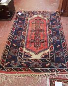 A Persian rug 204 x 130cm and another smaller